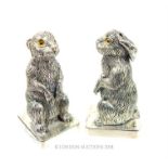 A pair of silver condiments in the form of rabbits