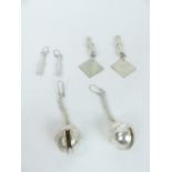 Three pairs of white metal earrings
