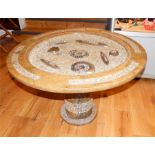 A circular occasional table formed of fossils