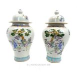 A pair of large, Chinese jars with covers