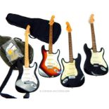 Four electric guitars in the style of Fender Stratocasters