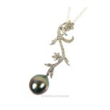 A 14 ct white gold, diamond and grey, South Sea pearl pendant and chain