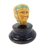 An ancient Egyptian-style head on an ebonised, wooden plinth base