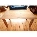 A rectangular pine dining table