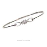 An 18 ct white gold and diamond bangle