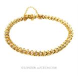 A 14 ct yellow gold and diamond-set, linked bracelet