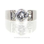 An 18 ct white gold, diamond solitaire ring with diamond set shoulders