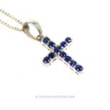 A 9 ct white gold and sapphire cross pendant on a 9 ct white gold chain