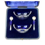 A cased pair of Edwardian sterling silver salts