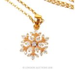 An 18 ct yellow gold and diamond snowflake pendant on 18 ct yellow gold chain