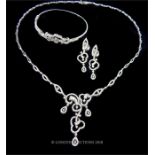 An 18 ct white gold, contemporary, diamond studded set/ parure
