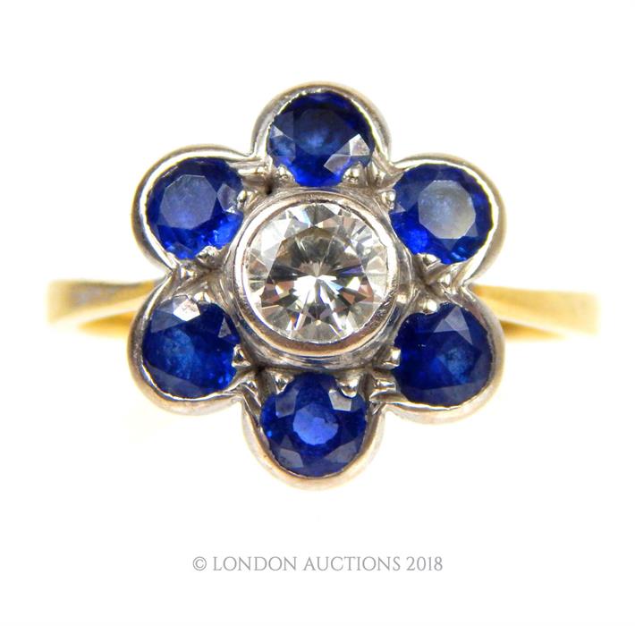 An 18 ct yellow gold, sapphire and diamond, flower-head ring