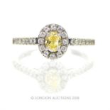 A platinum, fancy-yellow and white diamond cluster ring