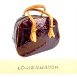 A Louis Vuitton, patent, monogrammed handbag