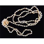A long, 1920's, strand of pink, baroque, freshwater pearls