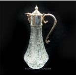 A press moulded glass claret jug with silver plated mount