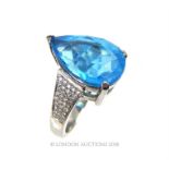 A white gold and substantial pear shaped blue topaz and diamond ring