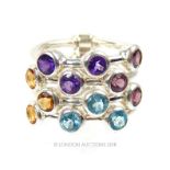 A sterling silver ring set with amethyst, blue topaz, citrine and garnet