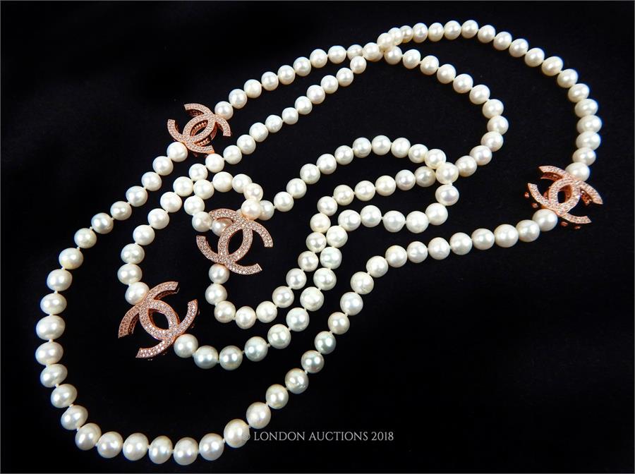 A long row of freshwater pearls with white crystal studded spacers