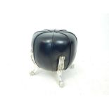 A black buttoned leather pouffle