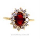 A 9 ct yellow gold, garnet and white sapphire cluster ring