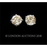 A pair of white gold diamond stud earrings