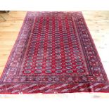 A fine Bokhara rug with red ground; 270cm x 193cm.