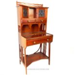 (In the manner of) Liberty's, an Arts and Crafts period bureau bookcase