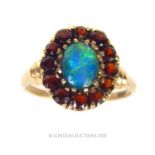 An antique, 9 ct yellow gold, blue opal and garnet cluster ring