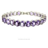 A sterling silver and faceted, amethyst bracelet