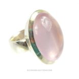 A substantial sterling silver and rose quartz cabochon ring
