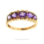 A 9 ct yellow gold, graduated amethyst and diamond ring