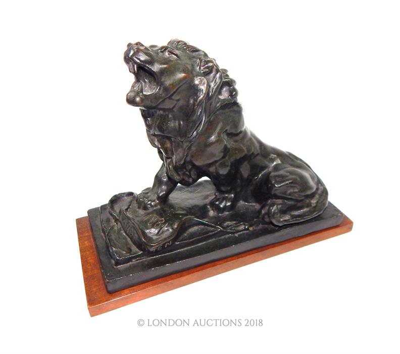 A bronze lion on wooden base, after Auguste Rodin