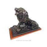 A bronze lion on wooden base, after Auguste Rodin