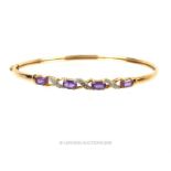 A 9 ct gold bangle with amethyst and diamonds. Condition: good. H: 0.4 cm W: 6.4 cm D: 5.4 cm 5 g