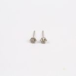 A boxed, pair of platinum and diamond solitaire stud earrings (0.30 carats total)