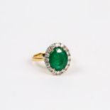 An 18 ct yellow gold, large emerald and diamond, cluster ring