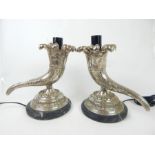 A pair of cast white metal cornucopia lamps