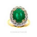 An 18 ct yellow gold, emerald and diamond cluster ring