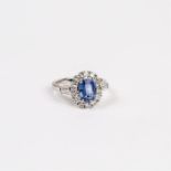 An 18 ct white gold, sapphire and diamond, cluster ring