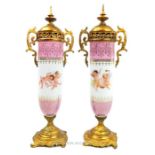 A pair of French style, porcelain vases with gilt metal mounts