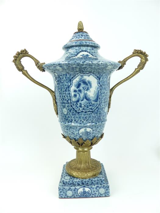 A large, Louix XVI style, porcelain blue and white urn and cover