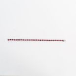 A boxed, 18 ct white gold, ruby and diamond, tennis bracelet