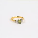 An 18 ct yellow gold, green and white diamond ring