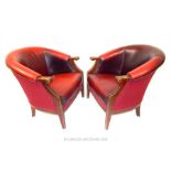 A pair of red leather tub chairs