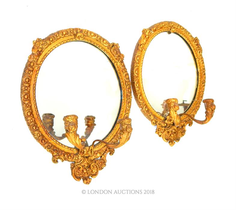 A pair of gilt-wood oval, girandoles