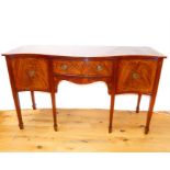 A Georgian style mahogany serpentine fronted sideboard
