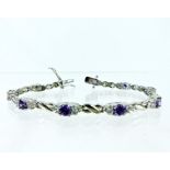 A sterling silver, purple and white faceted crystal, linked bracelet