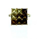 A 10 ct yellow gold topaz & citrine, studded ring