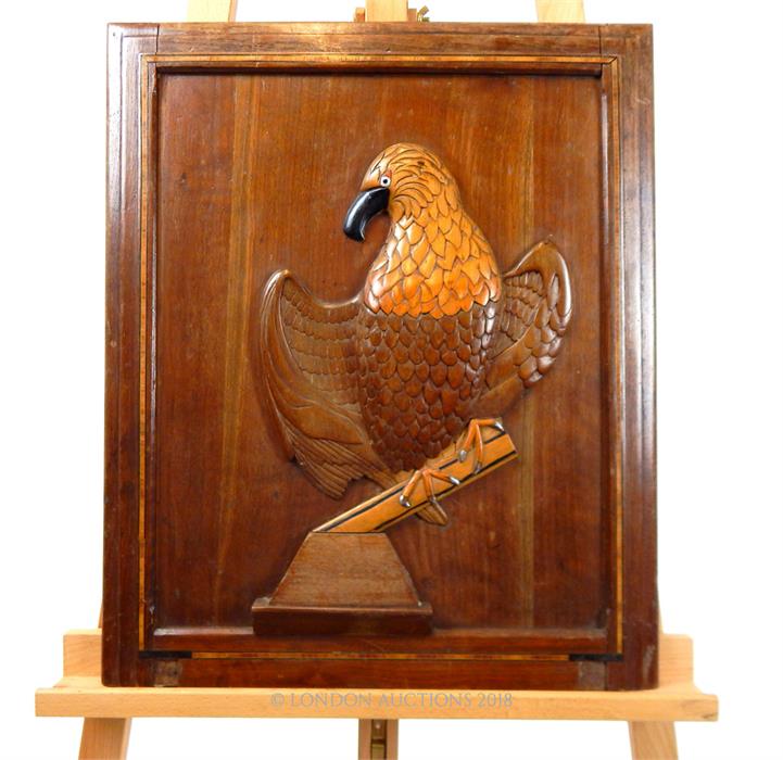 A carved eagle on a hardwood panel